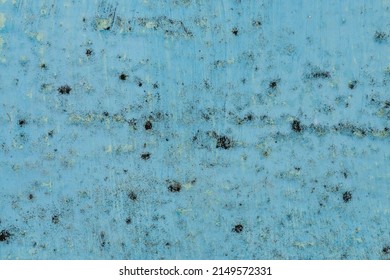 Black spots of mold and fungal bacteria on a blue wall in a house or apartment. The concept of excessive humidity, improper air exchange and condensation. Too bad for health.