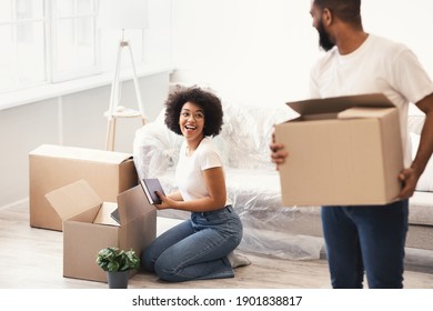 Black Spouses Packing For A House Move Carrying Packed Boxes Indoors. Young Family Housing, Real Estate Purchase And Apartment Rent, Relocation Concept. Selective Focus