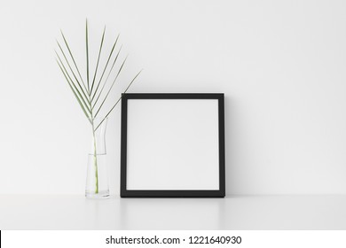 Black Square Frame Mockup With Palm Leaf In A Glass Vase.