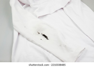 Black Stain On White Clothes. Dirt On Children's Clothes