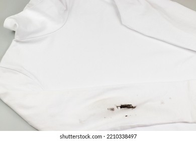 Black Stain On White Clothes. Dirt On Children's Clothes