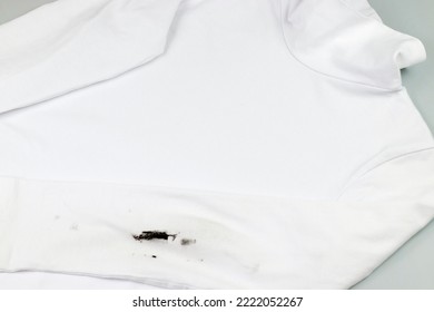 Black Stain On White Clothes. Dirt On Children's Clothes