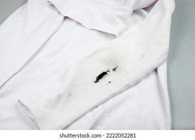 Black Stain On White Clothes. Dirt On Children's Clothes