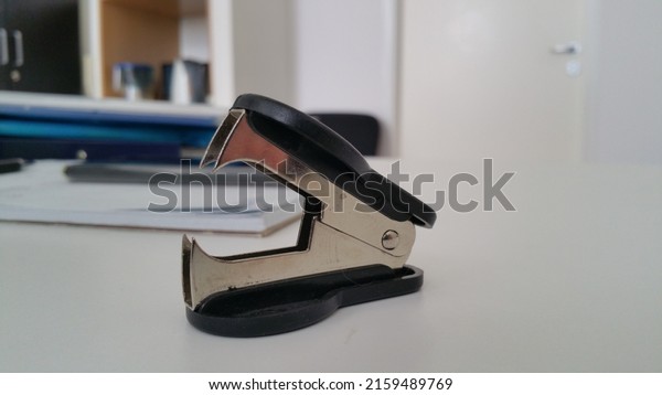 black staple remover on\
the office desk