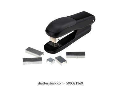 Black stapler and piles of copper office staples isolated on a white background