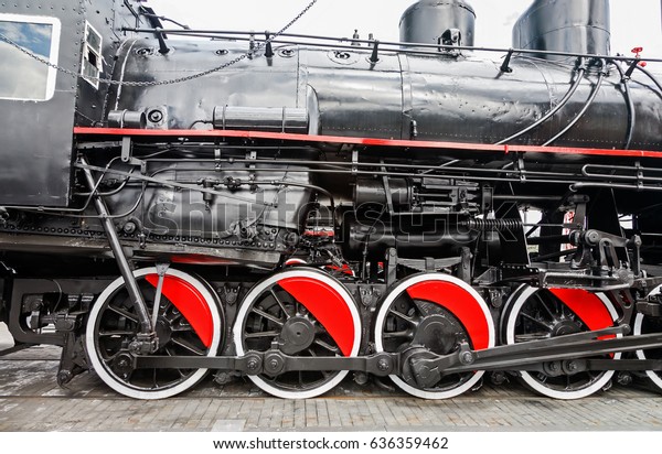 Black steam engine. The locomotive on the\
railroad. The train is ready to move forward. Retro locomotive\
black. Black steel car. Steam\
engine.