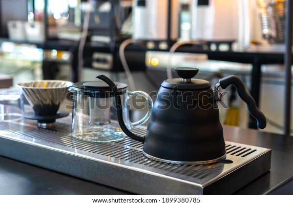 Black steel\
kettle for dip coffee in Coffee\
shop