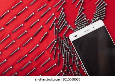 Black Steel Nails, Arranged Horizontally Next To Mobile Phone, Space For Advertising
