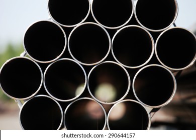 Black Steel Pipe Bundle In Industrial Stockyard.