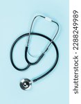 Black stethoscope for doctor diagnostic coronavirus disease, medical tool for health on blue background with copy space.