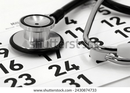 black stethoscope on calendar page, concept for scheduling a doctor's appointment or annual checkup