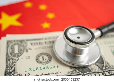 Black Stethoscope On China Flag Background With US Dollar Banknotes, Business And Finance Concept.