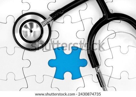 black stethoscope on white puzzle with missing piece and blue copy space, medical concept image represents a missing diagnosis