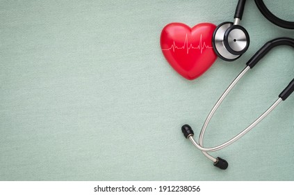 Black Stethoscope, Red Heart With Cardiogram For Check-up On Table Background. Stethoscope Equipment Of Doctor Medical Use To Diagnose Heartbeat. World Heart Day. Health Care And Cardiology Concept.