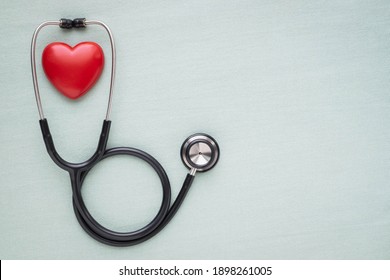 Black stethoscope and red heart doctor for check up light green background  Stethoscope equipment medical use to diagnose hear sound  Health care   cardiology concept and copy 