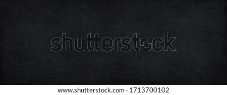 Black stone background with copy space for design. . Wide banner.  Concrete wall surface texture.