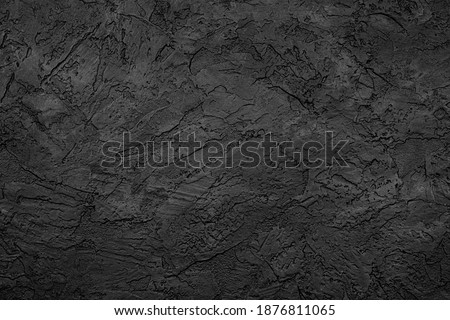 Black stone background texture. Black stone plaster cement. Grunge wall. Graphite