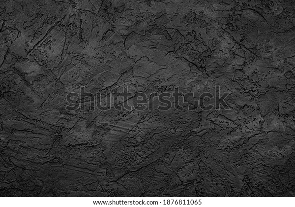 Black stone background texture. Black stone\
plaster cement. Grunge wall.\
Graphite