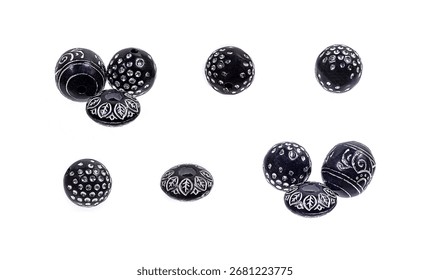 Black stone beads with a silver pattern on a white background.