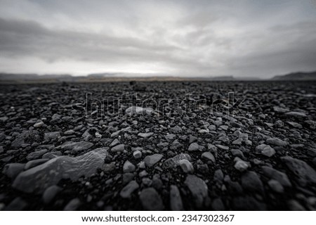  black stone field of sólheimasandur on iceland. low angle view of round volcanic stones on the coast of iceland.
