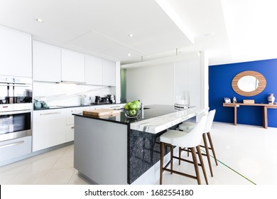 Black Stone Kitchen Bench With A Blue Feature Wall In A Hotel