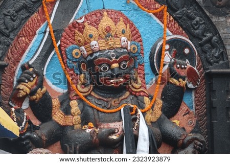 Black stone statue of Hindu god Kaal Bhairava who is an incarnation of lord Shiva in Durbar square. Satanic temple and worship of Pagan deity of old African tribe.  Stock photo © 