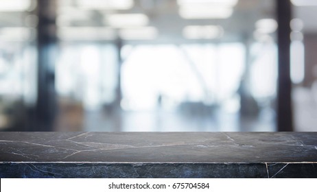 Black stone table top and blurred bokeh office interior space background - can used for display or montage your products. - Shutterstock ID 675704584