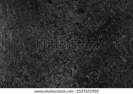 Black stone texture. Smooth and polished black stone, frontal view.