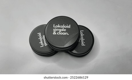 A black storage case with a round shape that is very elegant and minimalist