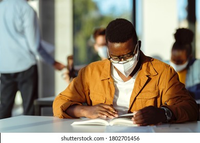 Black Student Wearing Protective Face Mask While Studying In Lecture Hall During Coronavirus Epidemic. 