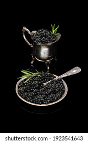 Black sturgeon caviar in retro vintage dish isolated on a black background. seafood diet food