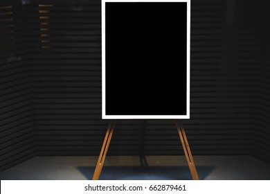 Black stylish chalkboard with mock up copy space are for your text message or advertising promotional content, empty presentation wooden board standing on the glass storefront
