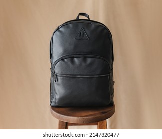 Black Stylish Leather Backpack On A Beige Background. Classic Accessories For Business. Bag For Things