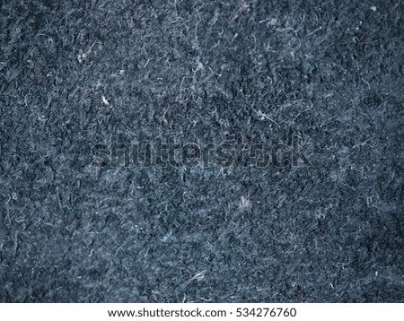 Black suede texture close up as background for design. Toned image