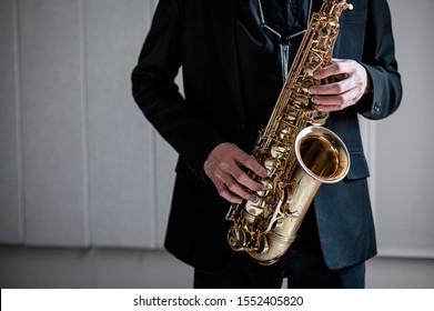 Black suit man playing saxophone - Shutterstock ID 1552405820