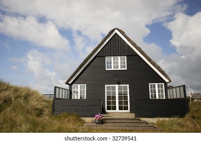 Black Summer House In Green Grass Dune. Summer In Denmark.