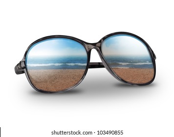 Black Sun Glasses Have A Beach With Sand Reflecting On An Isolated White Background. Use It For A Vacation Or Summer Concept.