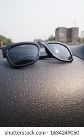 Black Sun Glasses On Car Console 