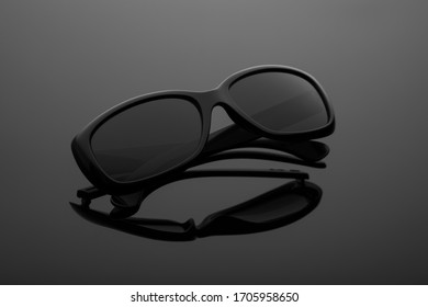 Black sun glasses gray gradient background