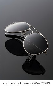 black sunglasses close-up on a black background, studio vertical photo - Shutterstock ID 2206420283