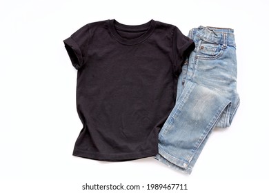 Black T Shirt Mockup On White Table Background With Jean. Template, Flat Lay. Kid, Child Clothes.