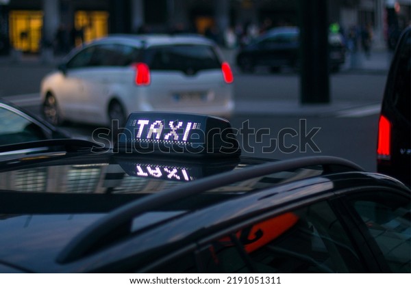 black taxi in streets at\
evening