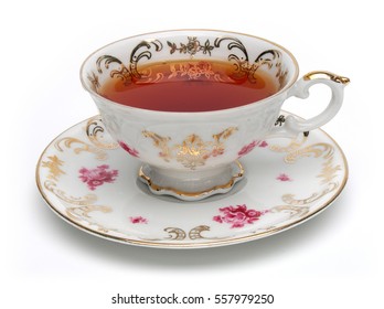 Black tea in antique tea cup isolated on white background