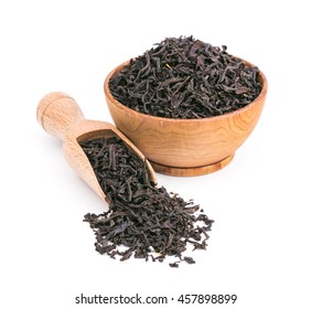 Black Tea Dry Leaves In A Wooden Bowl Isolated On White