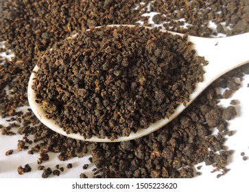 Black tea granules. Tea is an aromatic beverage commonly prepared by pouring hot or boiling water over cured leaves of the Camellia sinensis, an evergreen shrub (bush) native to East Asia.