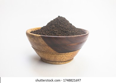 Black Tea Powder Or Dry Dust Tea Powder, Chai Patti Isolated In Wooden Bowl.