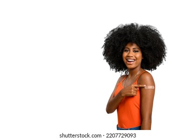 Black Teen Girl Smile And Points To Her Arm With Vaccine Sticker, She Does Not Wear Face Shield,looking At Camera Isolated On White Background.