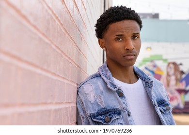 Black Teen Male Model With Short Curly Black Hair Outside On Sunny Afternoon