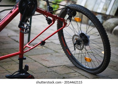 A Black Teenage Boy Repairing A Flat Bike Tyre