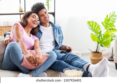 Black Teenage Couple Watching Tv, Sitting On Couch With Popcorn At Home, Free Space